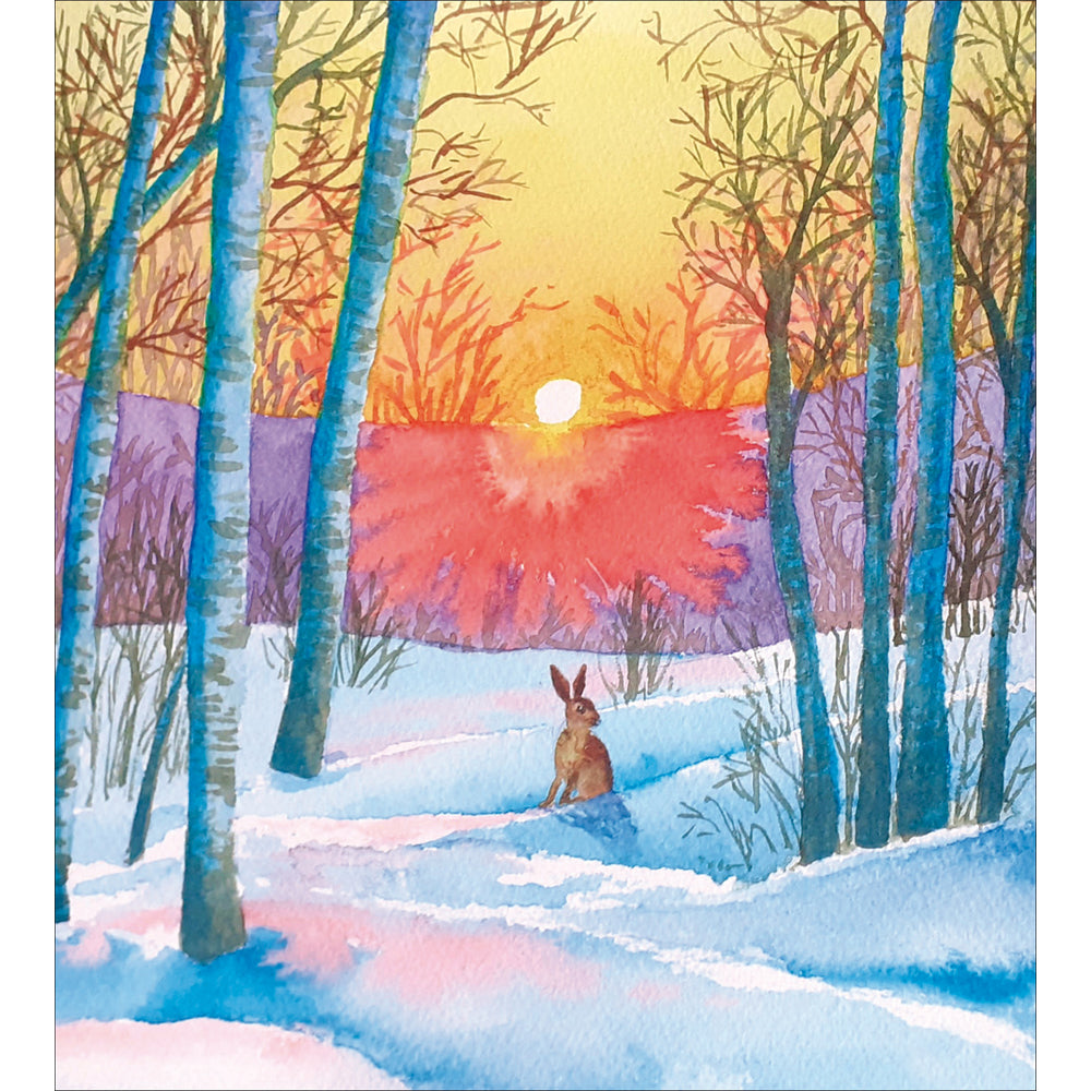 An image of a christms greetings card with a cockapoo sitting infront of a christmas tree with pretend reindeer antlers on it's head.