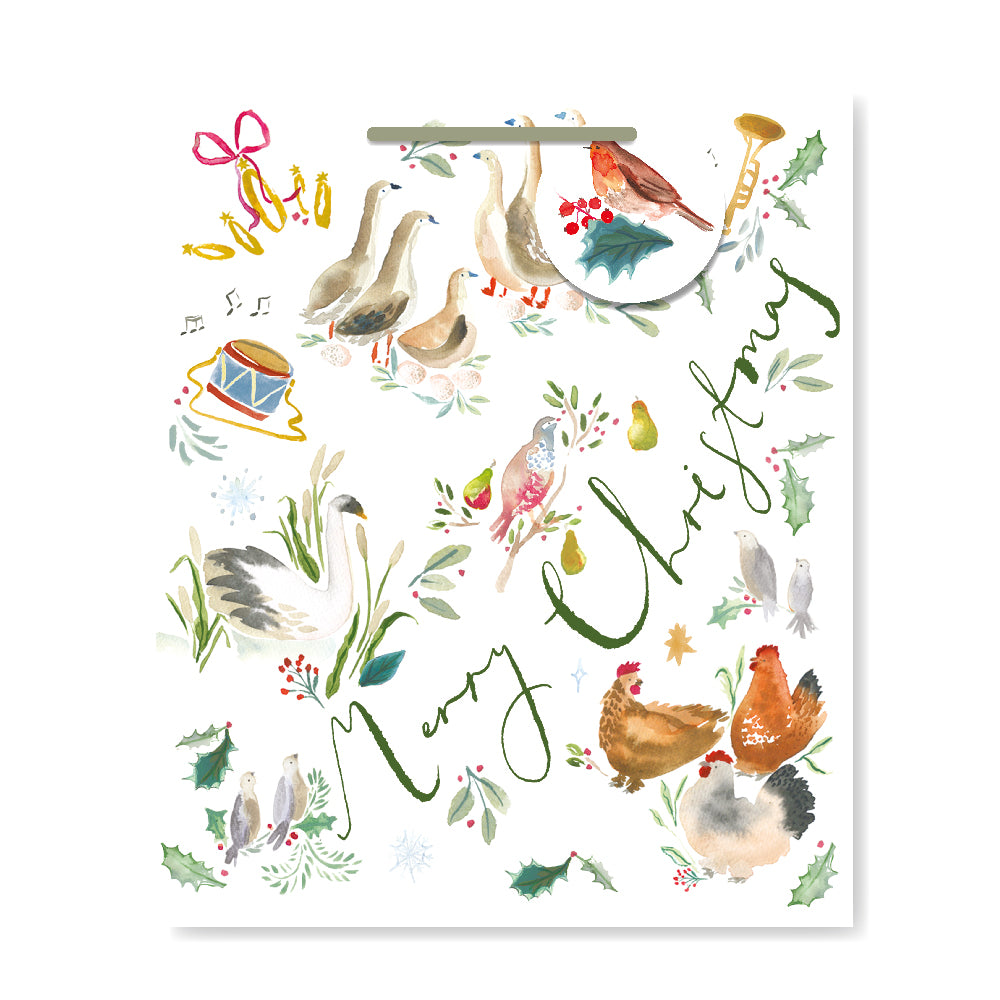 A white Christmas gift bag featuring a watercolour illustration of winter farm animals, including geese, chickens, and birds, with green cursive text reading 'Merry Christmas' and botanical accents.