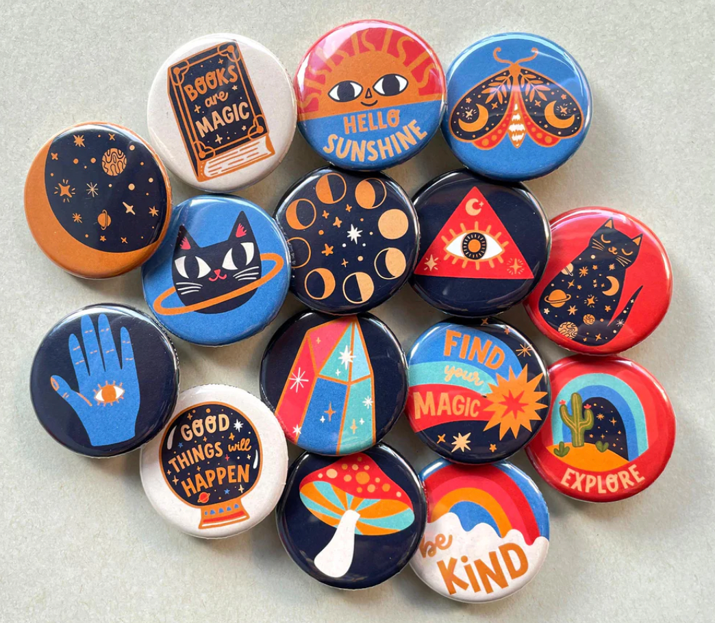 Cosmic magic badges by badge bomb on a table