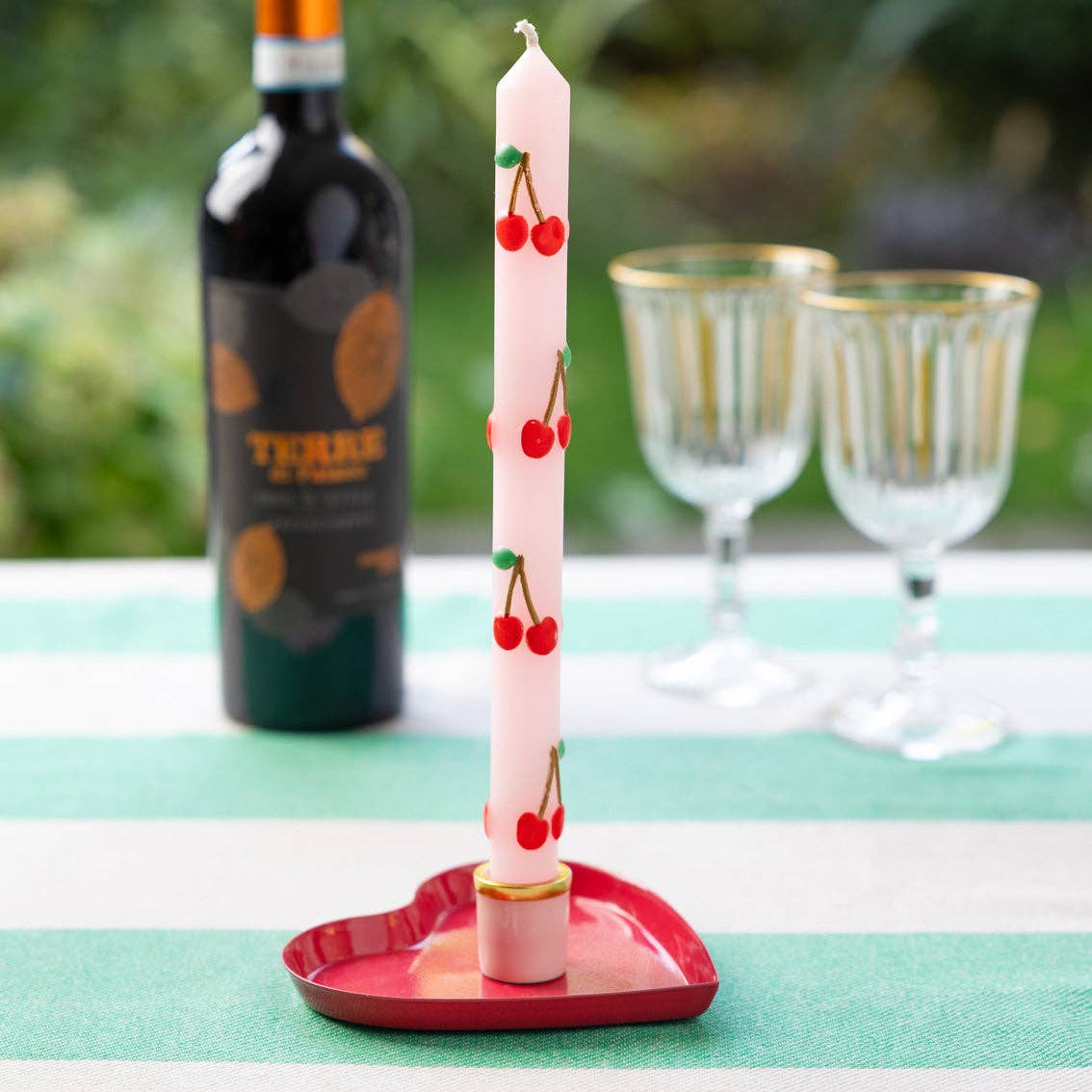 Cherry Dinner Candles Set 2 Pack shown in an enamel heart shaped candle holder by penny black