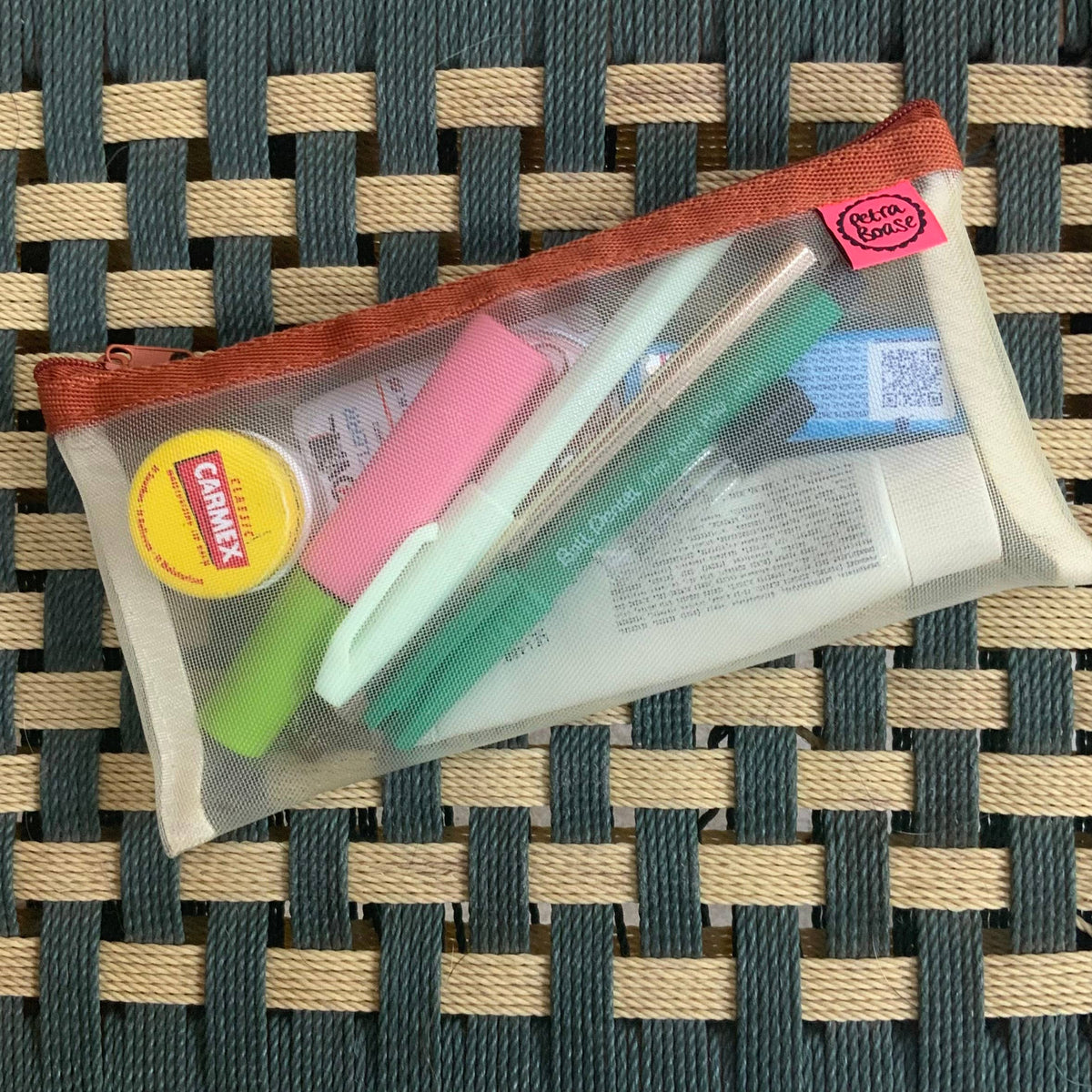 Handy Mesh Zip Case filled with bits and pieces from a hand bag