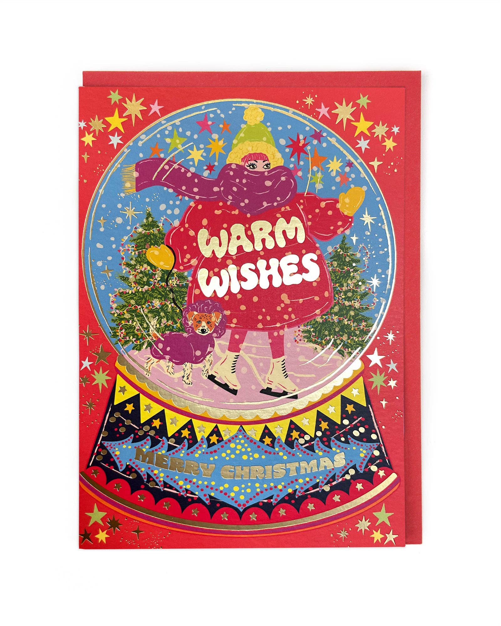 Christmas card with an ice skater in a red coat and hat in a snowglobe, with gold foil text on the jacket 'Warm Wishes' and 'Merry Christmas' on the bottom, with a red envelope.