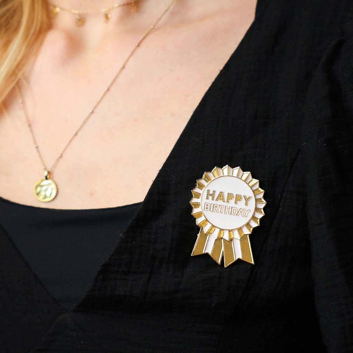 Gold Enamel Happy Birthday Pin Badge on someone's lapel by penny black
