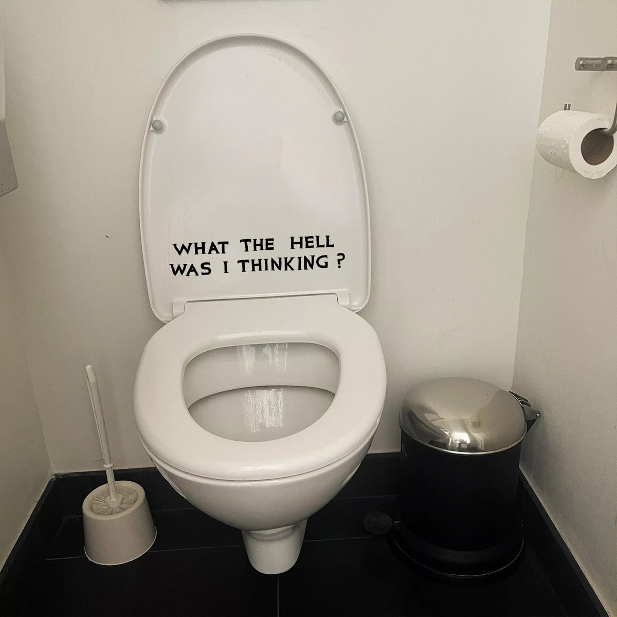 What The Hell Was I Thinking? David Shrigley Bumper Sticker by penny black shown on a toilet seat