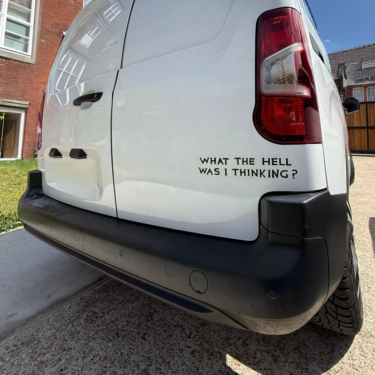 What The Hell Was I Thinking? David Shrigley Bumper Sticker by penny black shown on a van bumper