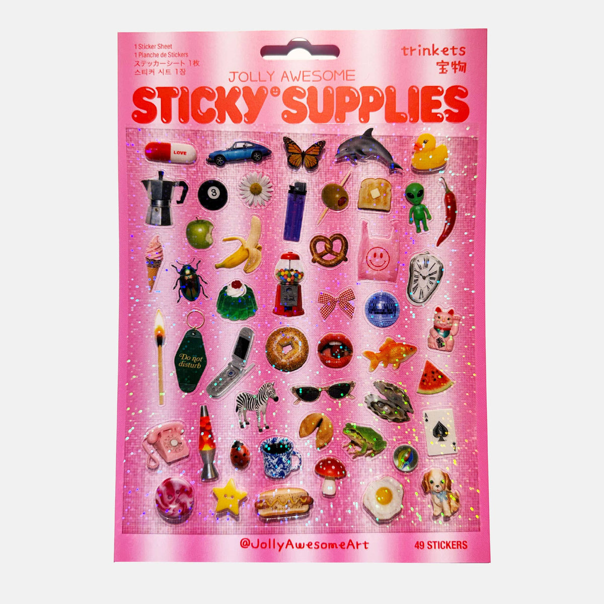 A pink package of 'Jolly Awesome Sticky Supplies' stickers, featuring 49 different colourful trinket themed stickers on a glittery pink backing card. The package includes various themed stickers like a coffee mug, donut, rainbow, sunglasses, and a frog.