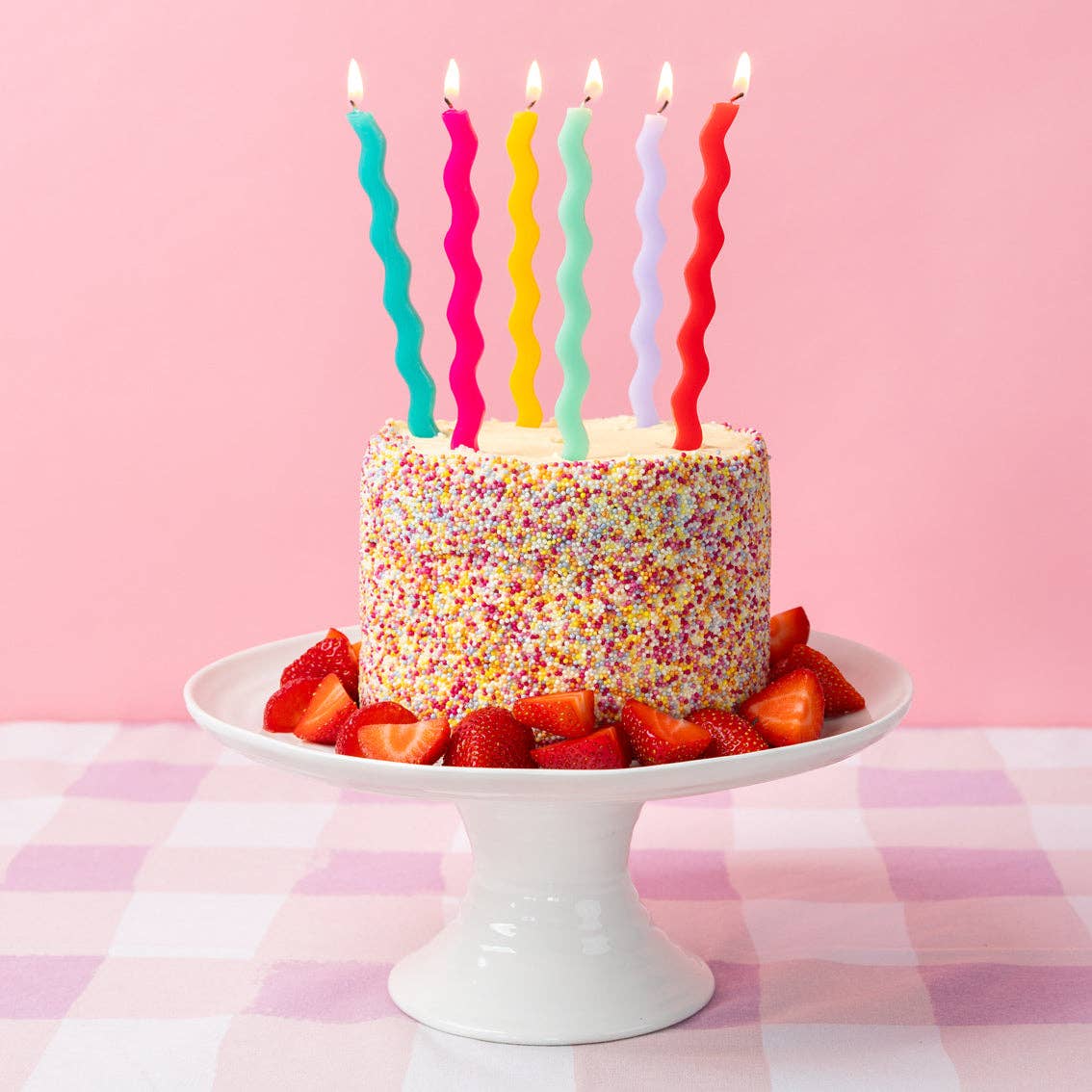 Colourful Wavy Tall Birthday Candle 12 Pack shown on top of a cake on a cake stand