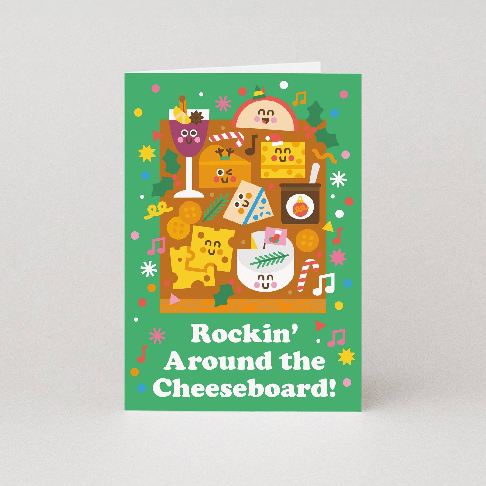 Card with festive cheeseboard design and text 'Rockin' Around the Cheeseboard!' on a green background.