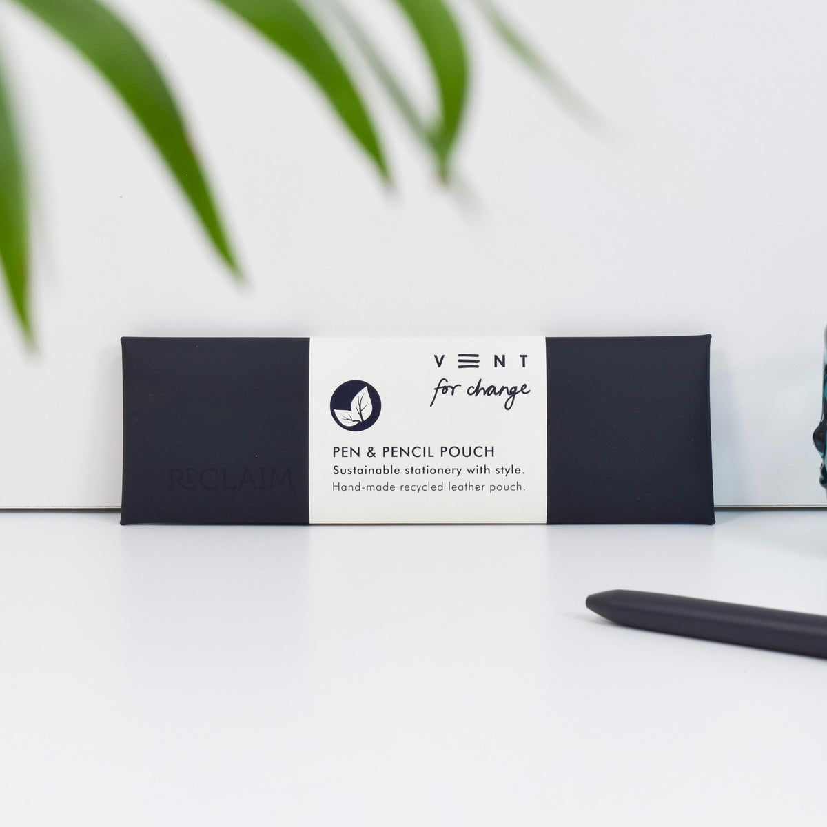 A black pen and pencil pouch made of recycled leather and has the word 'Reclaim' embossed in it.