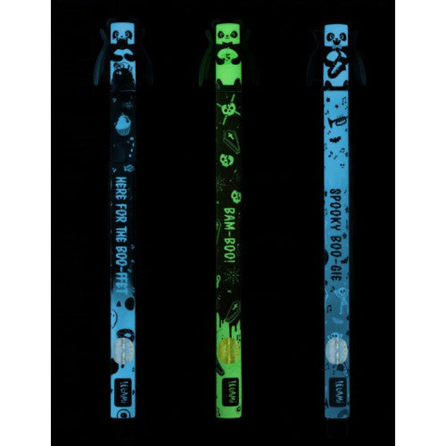 Three glow-in-the-dark Halloween-themed pens shown on a black background. Each has a cartoon panda at the top and spooky text on the shaft of the pens: 'HERE FOR THE BOO-FFET', 'BAM BOO', and 'SPOOKY BOO-GIE'.