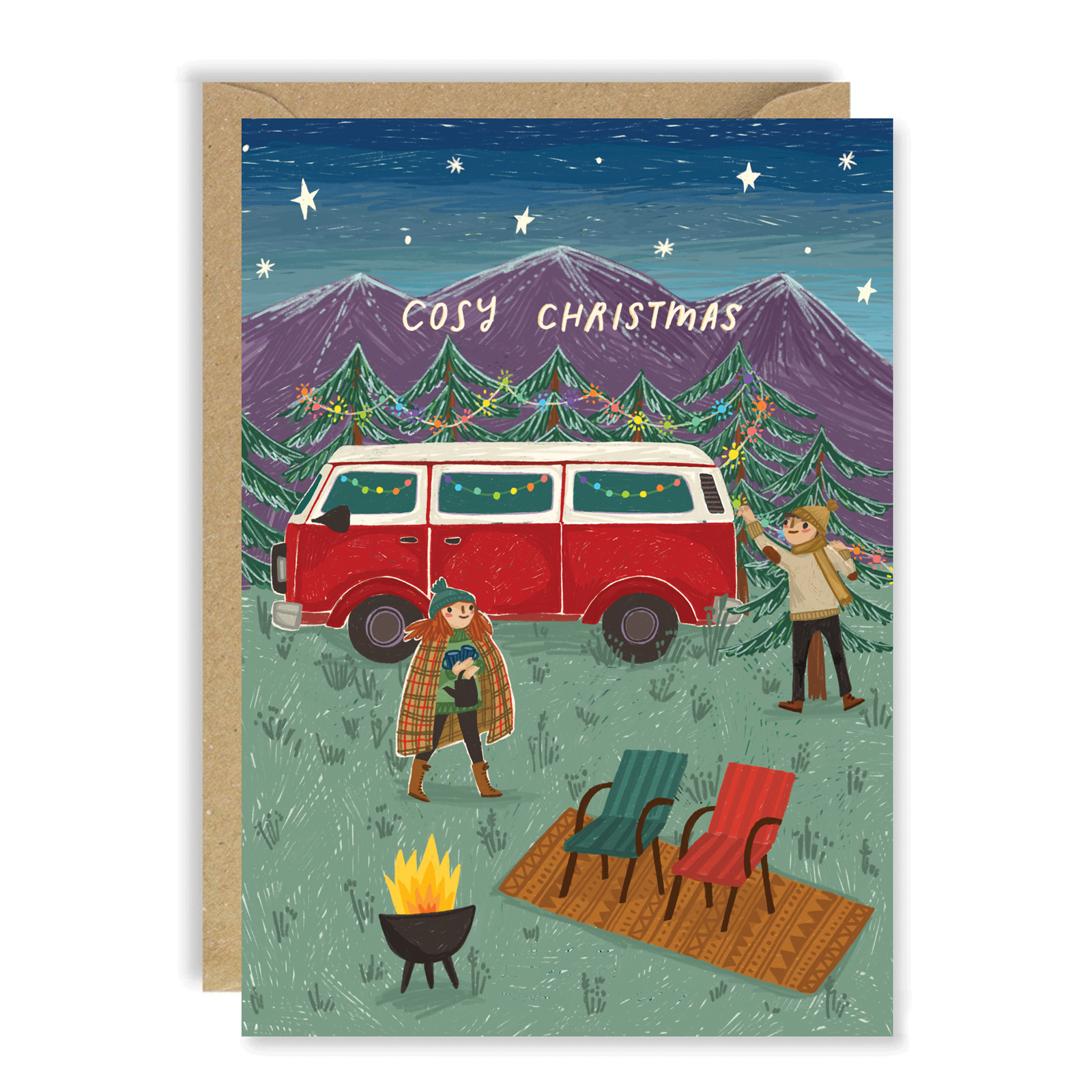 A Christmas greeting card with a kraft envelope, featuring an illustrated camping scene with a red van, mountains, trees, two people, a fire pit, and chairs. The card reads 'COSY CHRISTMAS'.