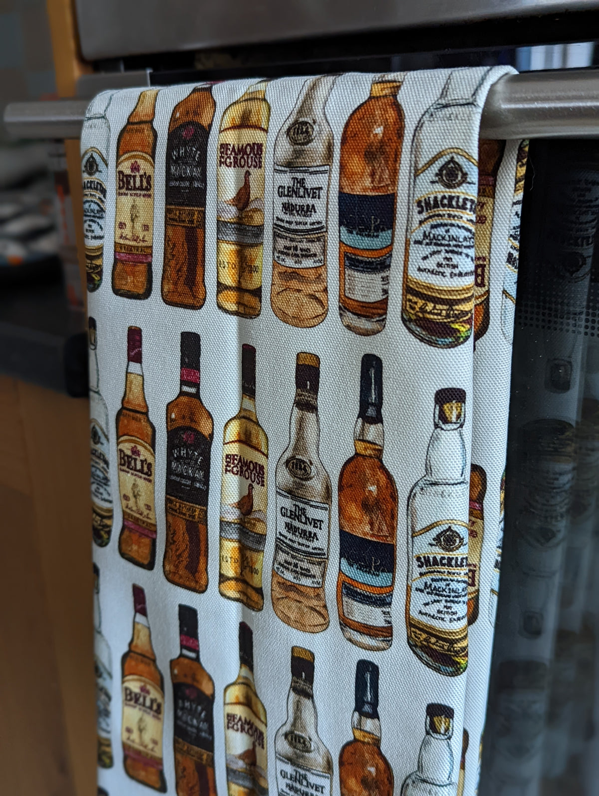 Illustrated Whisky Tea Towel By Penny Black showing in a kitchen