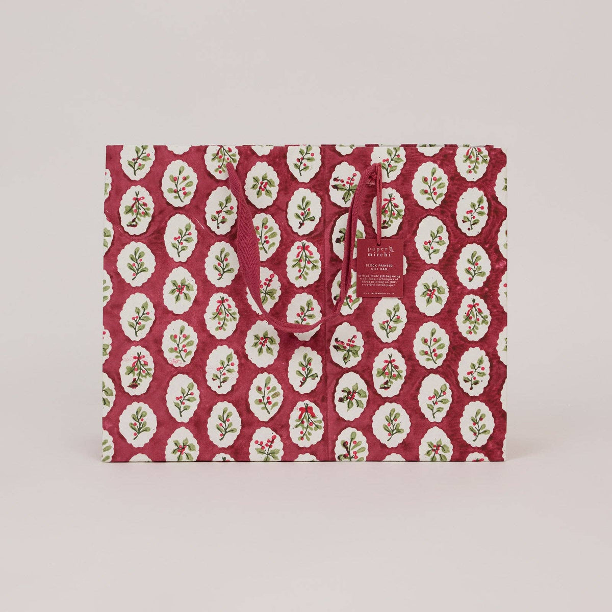A large christmas gift bag with scalloped design on a light gray background by paper mirchi at penny black
