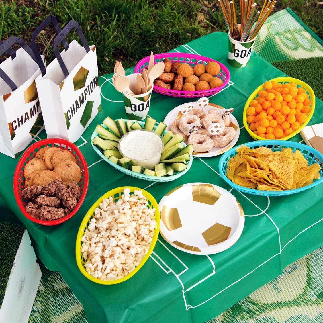 Football Pitch Paper Table Cover by penny black - shown laid on a table with snacks