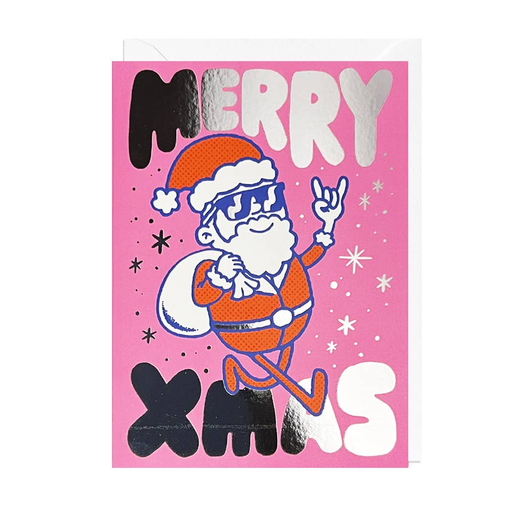A festive Christmas greeting card featuring a cartoon Santa Claus in an red suit and hat, making a rock-and-roll gesture, on a bright pink background with the words 'MERRY XMAS' in bold silver foil lettering.