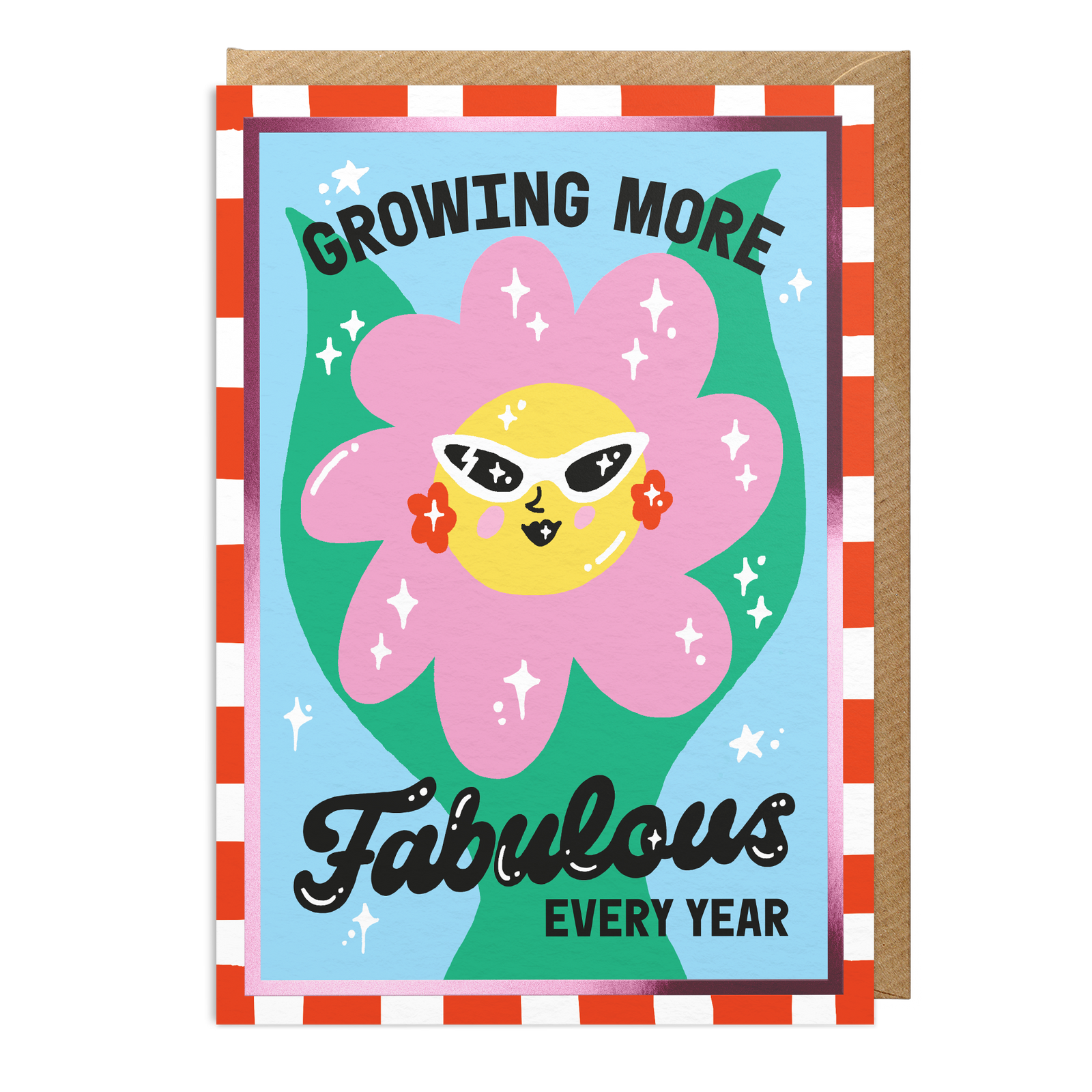 An A6 birthday greeting card with a retro-style illustration of a pink flower wearing yellow sunglasses, surrounded by the text 'GROWING MORE Fabulous EVERY YEAR'. The card has a checkered border and is shown with a brown kraft envelope behind it on a white background.