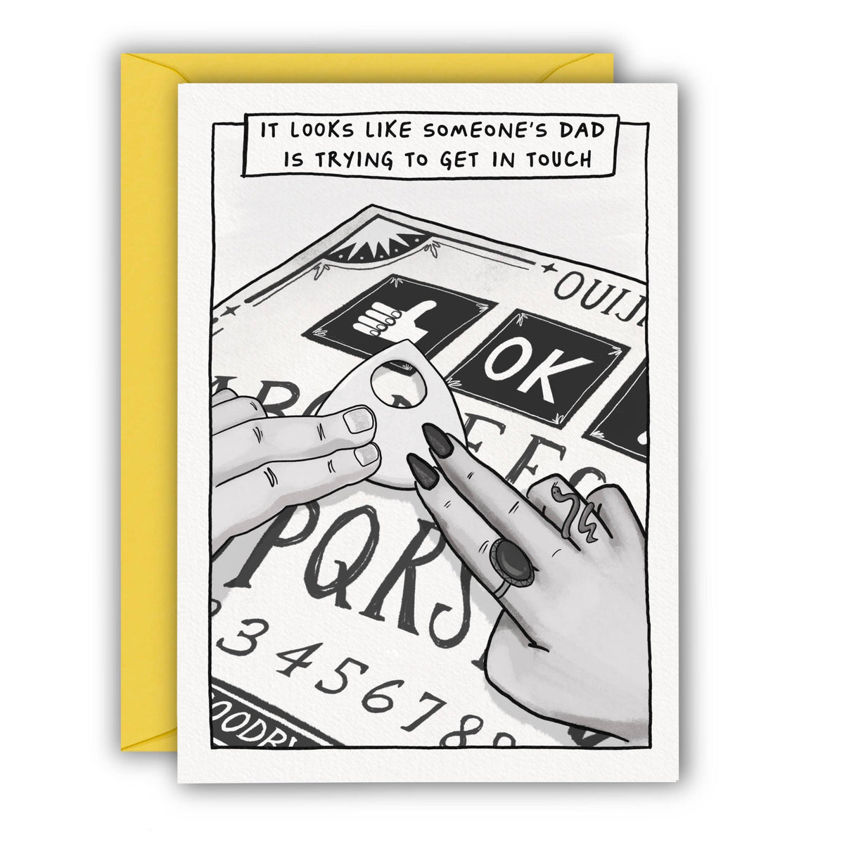 A white greeting card with a black-and-white occult-style illustration of hands over a Ouija board, with a yellow envelope behind it - words on the card read 'it looks like someone's dad is trying to get in touch' and the ouija board is selecting a thumbs up at penny black