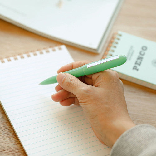 Penco Bullet Ballpoint Pen Light By Penny Black shown being used to write on a notepad