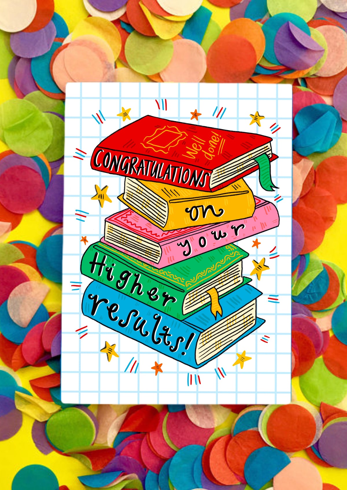 A greetings card with a white background covered in light blue squares like a jotter. The main image is a colourful jauntily stacked textbooks with the words 'Congratulations on your Higher results!' - one word on each book. This card is sitting on top of rainbow coloured confetti.